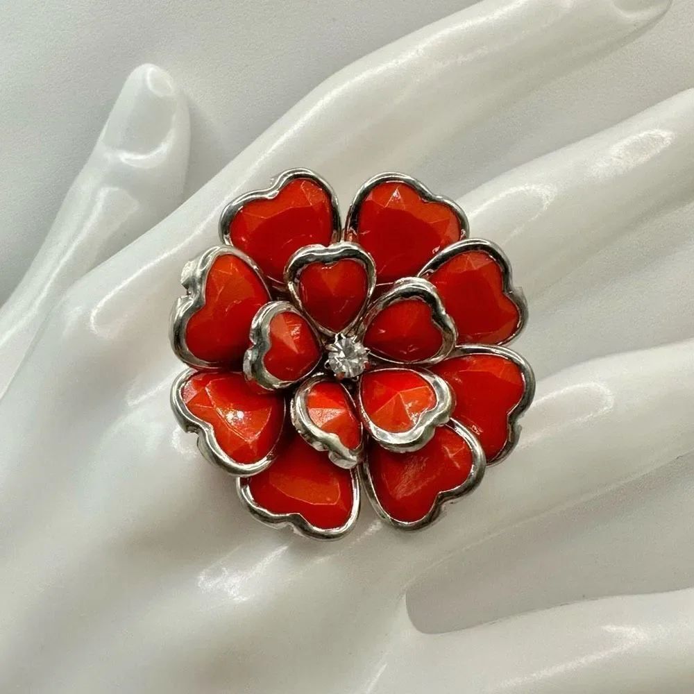 Orange and silver tone flowerāring